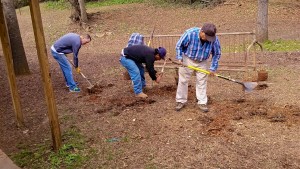 Workers prepare the bike rack's new site at Inman Middle School. VHCA Board member David Brandenberger shovelling at far left. Photo courtesy Jack White.