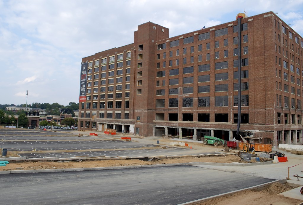 We walk from the building where the leasing center will be, past the newly laid surface parking lot and into the west side of the building.