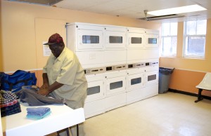 Resident Michael Rogers uses the newly renovated laundry room