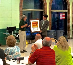 VHCA President Jack White presents Cory Rayburn, with the city's Department of Stormwater Management, with an award plaque.