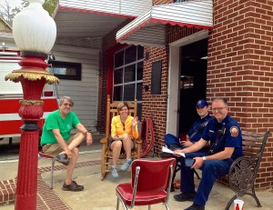 VHCA board members Jack White and Catherine Lewis, left and center, talk with firemen outside FS #19.