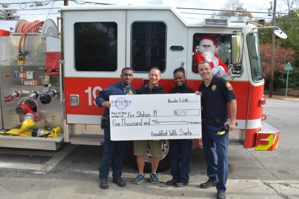 Doc Chey's owner Rich Chey presents the Fire Station 19 crew with the proceeds check from Brekafast with Santa. Photo credit Ashley Lepore